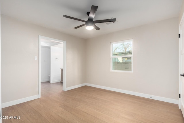 unfurnished room with baseboards, ceiling fan, and light wood finished floors