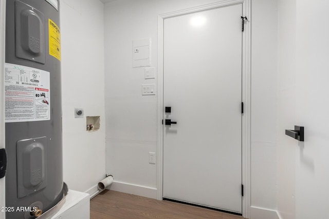 washroom with electric water heater, wood finished floors, hookup for an electric dryer, hookup for a washing machine, and laundry area