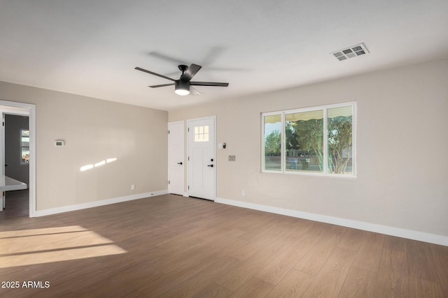 entryway with ceiling fan, visible vents, baseboards, and wood finished floors