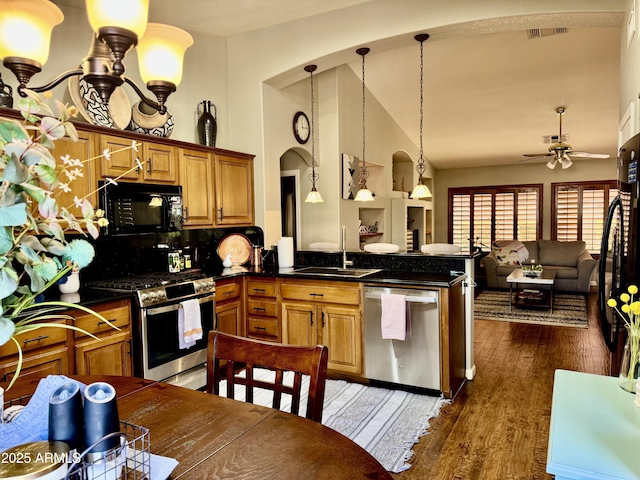 kitchen with visible vents, open floor plan, dark wood-style flooring, black appliances, and a sink