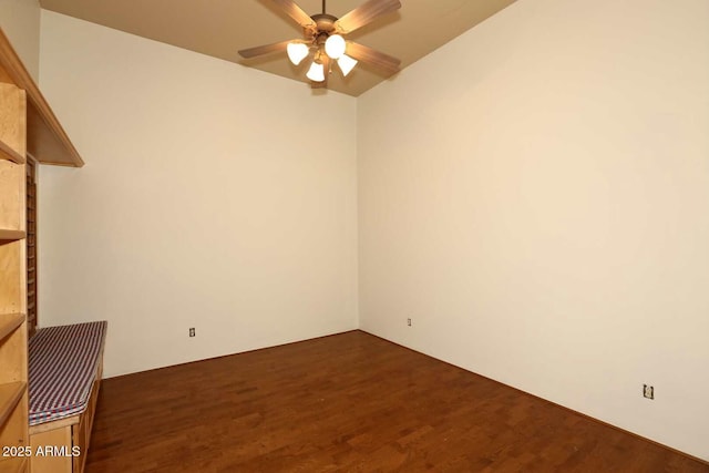 unfurnished room with dark wood-style flooring and a ceiling fan