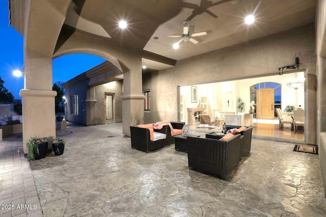 view of patio with an outdoor living space and ceiling fan