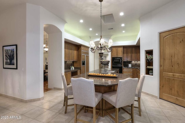 dining room with visible vents, baseboards, an inviting chandelier, recessed lighting, and light tile patterned flooring