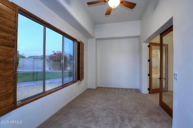 spare room featuring ceiling fan and carpet