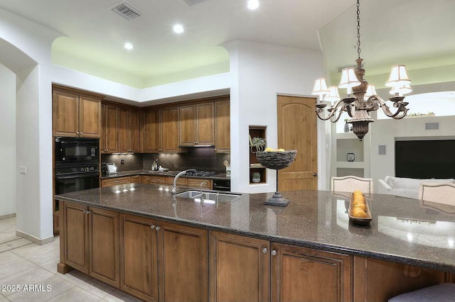 kitchen with visible vents, light tile patterned floors, a sink, black appliances, and backsplash