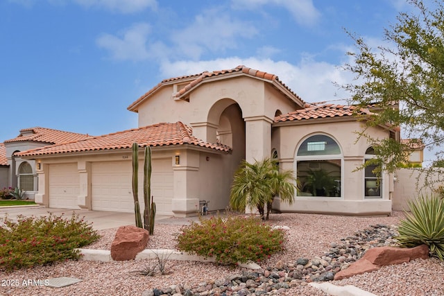 mediterranean / spanish-style house featuring a garage