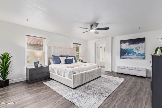 bedroom featuring ensuite bathroom, hardwood / wood-style floors, and ceiling fan