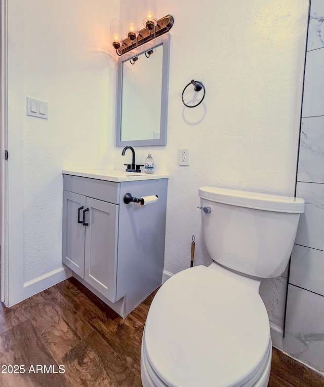 8445 S 7th Ave, Phoenix, AZ 85041 - bathroom with vanity, wood finished floors, toilet, and baseboards