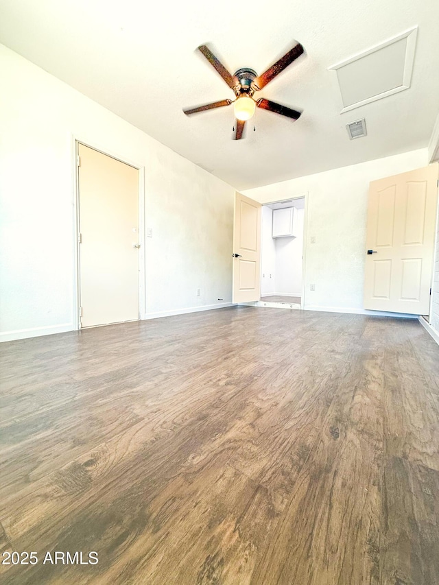 8445 S 7th Ave, Phoenix, AZ 85041 - unfurnished bedroom featuring wood finished floors, attic access, baseboards, and ceiling fan