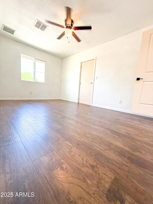 8445 S 7th Ave, Phoenix, AZ 85041 - spare room featuring a ceiling fan, wood finished floors, and baseboards