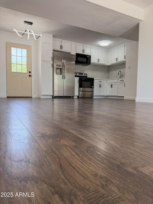 8445 S 7th Ave, Phoenix, AZ 85041 - kitchen with appliances with stainless steel finishes, a chandelier, white cabinets, baseboards, and backsplash
