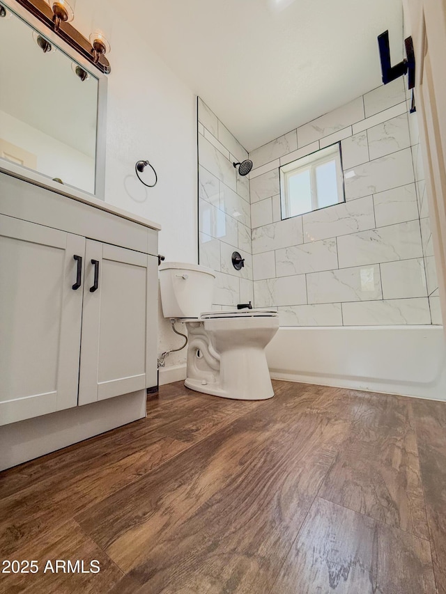 8445 S 7th Ave, Phoenix, AZ 85041 - bathroom with toilet, washtub / shower combination, vanity, and wood finished floors