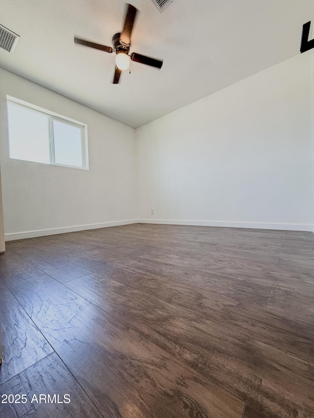 8445 S 7th Ave, Phoenix, AZ 85041 - empty room featuring a ceiling fan, dark wood-style floors, and baseboards
