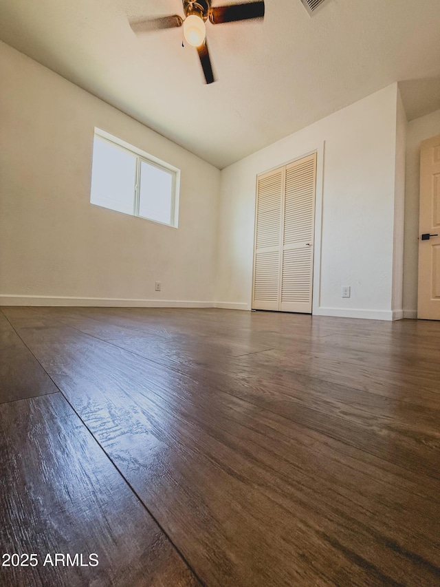 8445 S 7th Ave, Phoenix, AZ 85041 - unfurnished room featuring a ceiling fan, baseboards, and dark wood-type flooring
