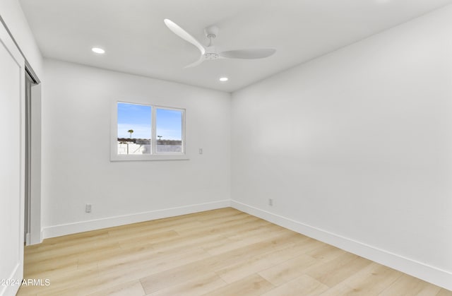 unfurnished bedroom featuring light wood-type flooring, a closet, baseboards, and recessed lighting