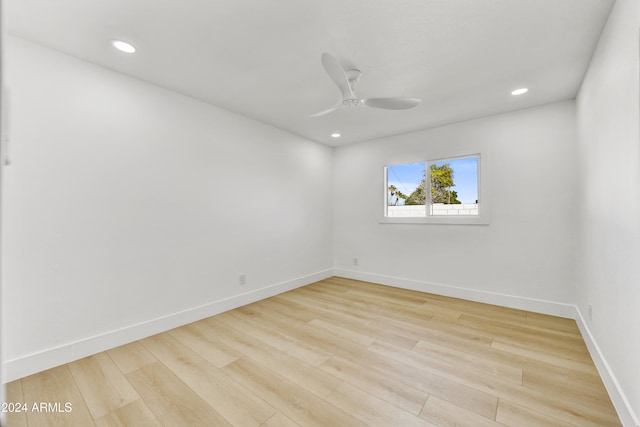 spare room featuring a ceiling fan, baseboards, wood finished floors, and recessed lighting