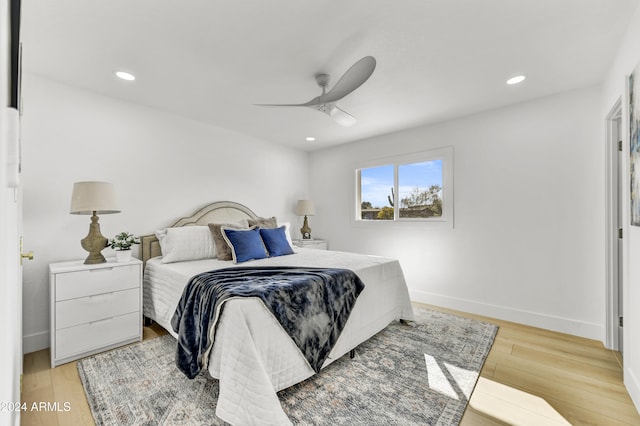 bedroom featuring a ceiling fan, recessed lighting, light wood-style flooring, and baseboards