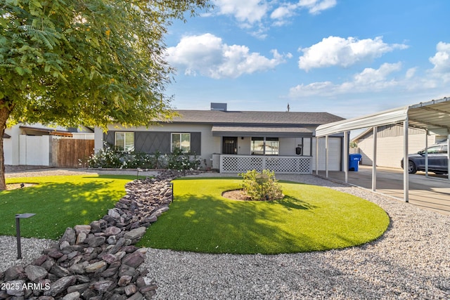 single story home featuring a carport, a porch, a garage, and a front lawn