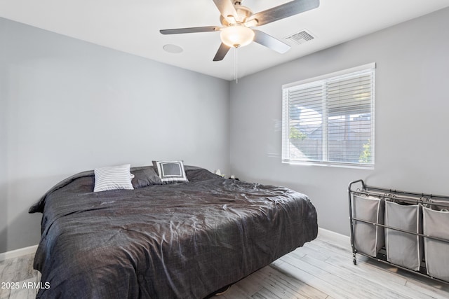 bedroom with ceiling fan and light hardwood / wood-style floors