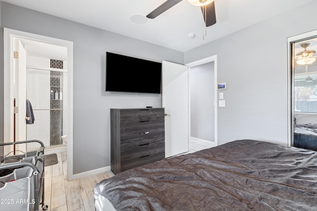 bedroom with ceiling fan, light wood-type flooring, and ensuite bath