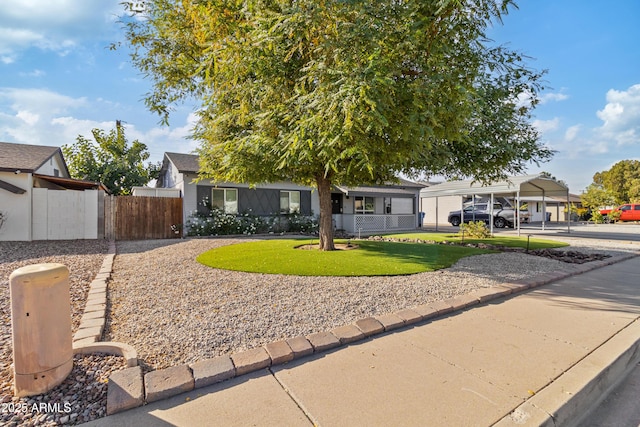 view of front of home featuring a front lawn and a carport