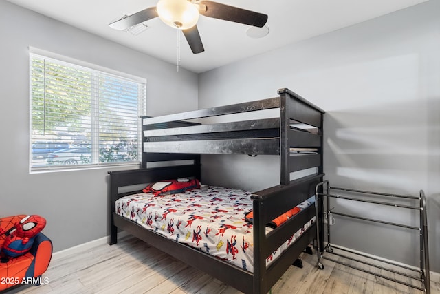 bedroom with light hardwood / wood-style flooring and ceiling fan