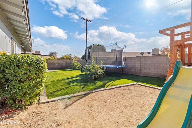 view of yard featuring a playground and a trampoline