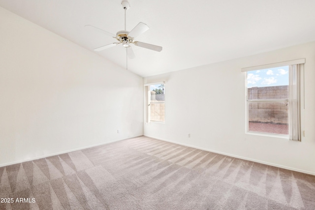 carpeted empty room with ceiling fan and lofted ceiling