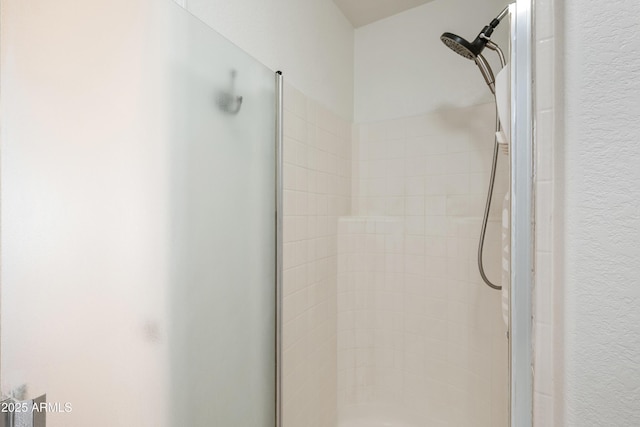 interior details featuring an enclosed shower