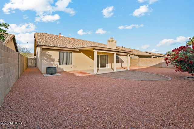 back of house with central AC unit and a patio