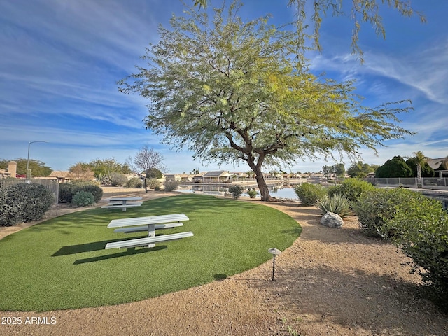 view of home's community with a yard