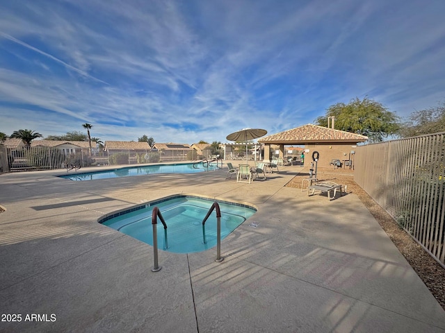 view of pool with a patio area and a community hot tub