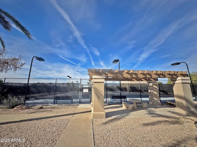 exterior space with a pergola and tennis court