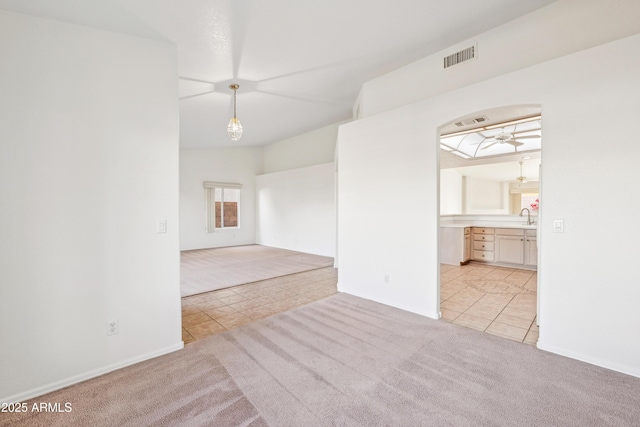 tiled spare room with ceiling fan and sink