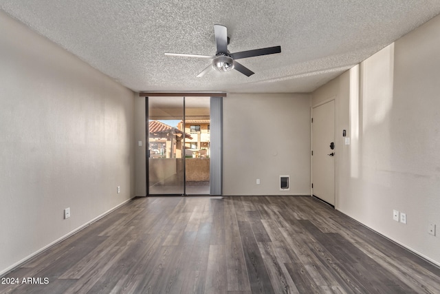 unfurnished room with ceiling fan, dark hardwood / wood-style flooring, and a textured ceiling