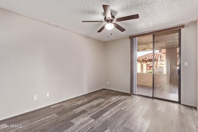 unfurnished room featuring wood-type flooring, a textured ceiling, and ceiling fan