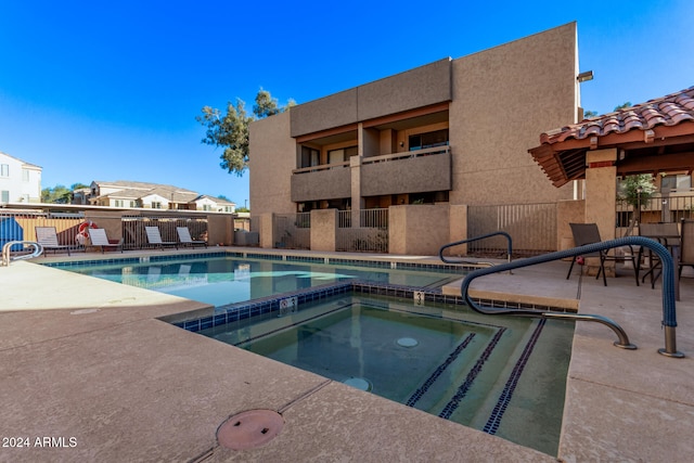 view of pool with a community hot tub