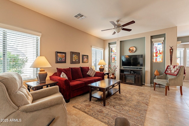 tiled living room featuring ceiling fan and plenty of natural light