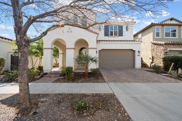 mediterranean / spanish-style house with a garage