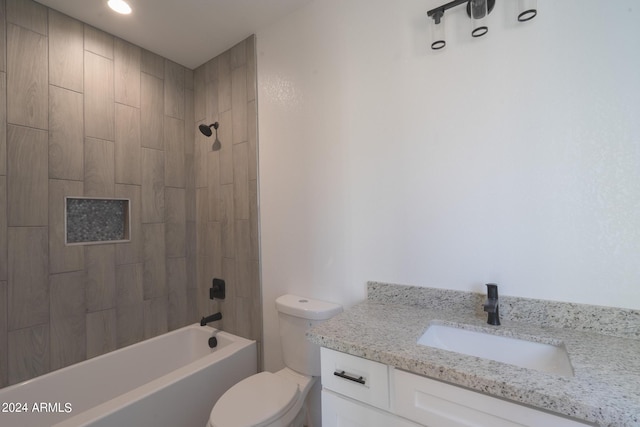 full bathroom featuring tiled shower / bath combo, vanity, and toilet