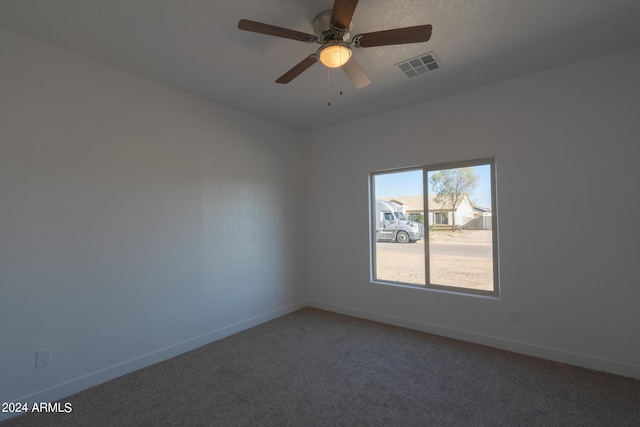 carpeted spare room with ceiling fan