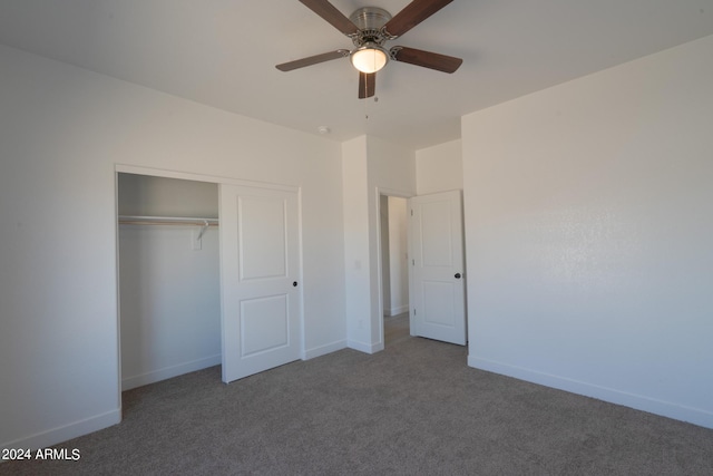 unfurnished bedroom with ceiling fan, dark colored carpet, and a closet