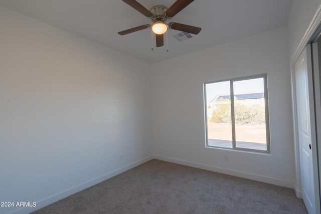 empty room with carpet and ceiling fan