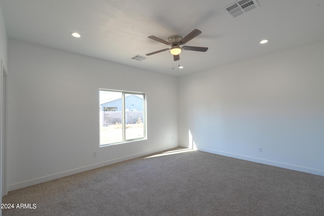 carpeted empty room featuring ceiling fan