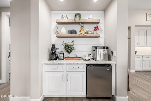 bar featuring fridge, baseboards, light wood finished floors, and recessed lighting