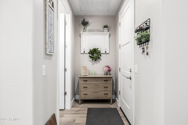 entryway with light wood-type flooring and baseboards