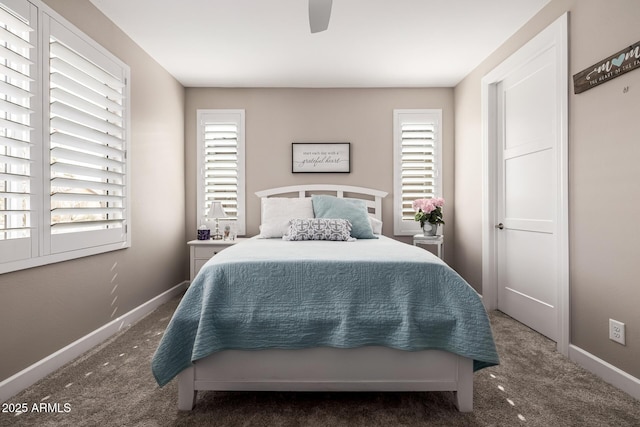 bedroom with carpet, multiple windows, and baseboards