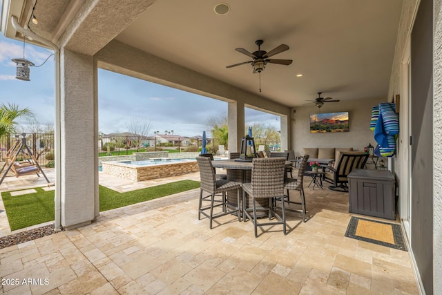 view of patio with a fenced in pool and ceiling fan