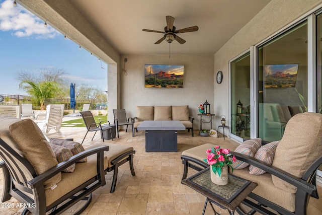 view of patio featuring outdoor lounge area, fence, and ceiling fan