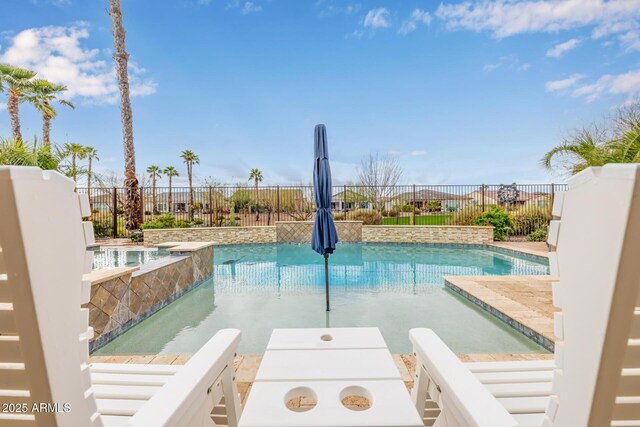 view of swimming pool with a fenced in pool, fence, and an in ground hot tub